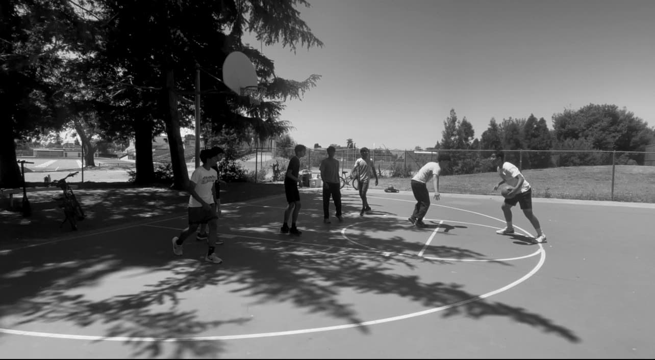 A pickup basketball game on an outdoor court in Fremont